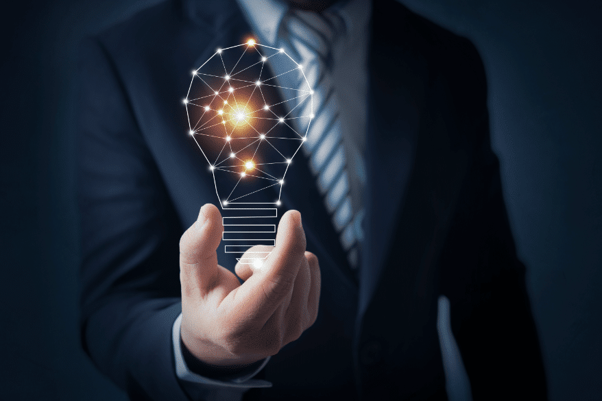 business-man-holding-bright-light-bulb-in-hand