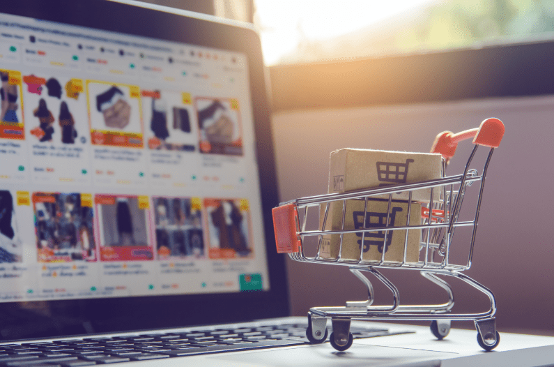 parcel-or-paper-cartons-with-shopping-cart-logo-in-trolley-on-laptop-keyboard